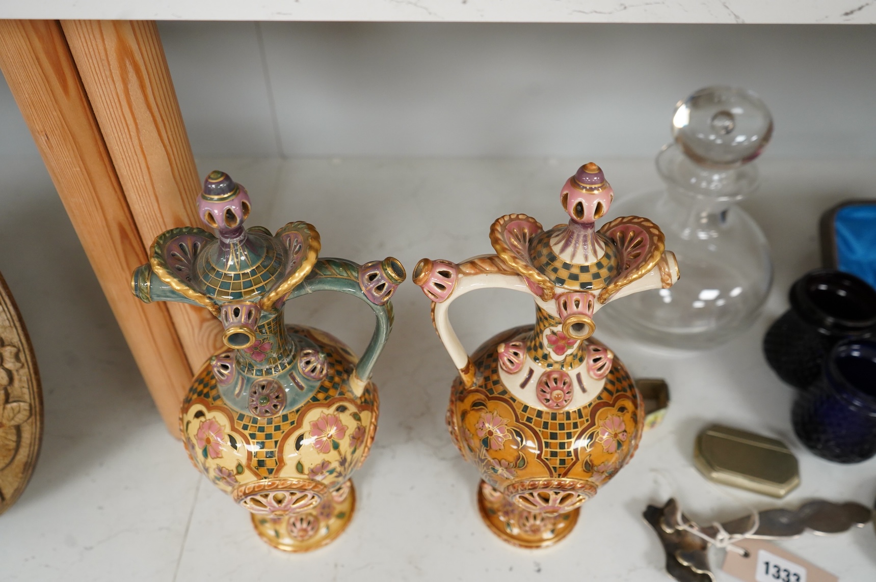 Two Zsolnay Persian inspired jugs / ewers and covers, stamped to the bases 29cm high